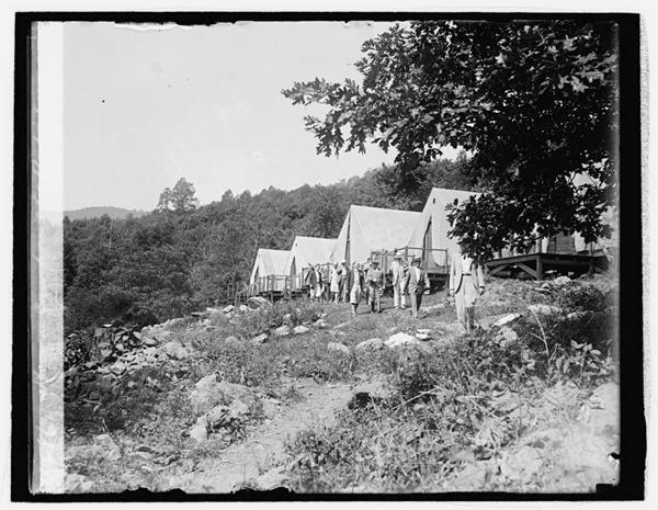Several large white tents in a row.