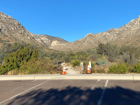 A trail is marked by two orange cones