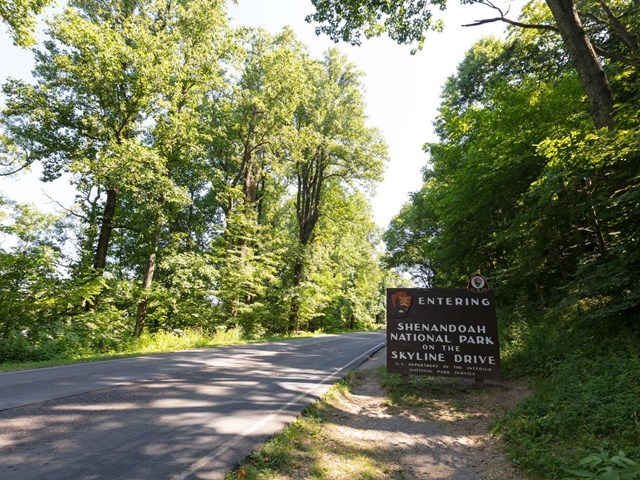 A color photograph of a sign for the Rockfish Entrance Station, located ahead.