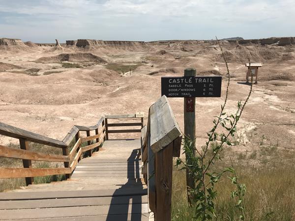 Wooden boardwalk gives way to rolling badlands formations and a meandering trail.