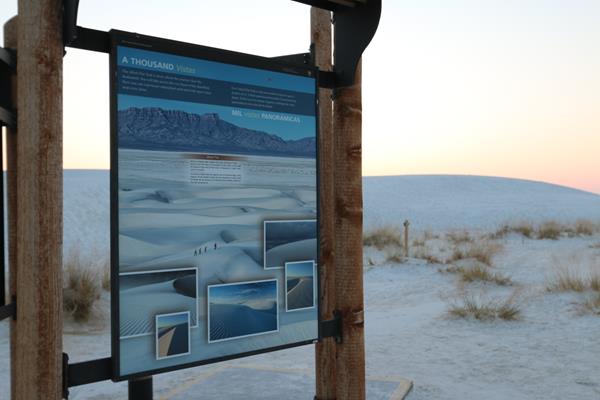 Sign with multiple pictures of white dunes.