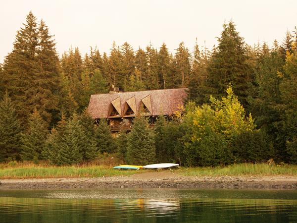 a large building in a forested area on a beach