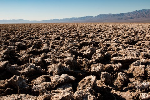 Sharp, eroded salt formations stretch into the background.