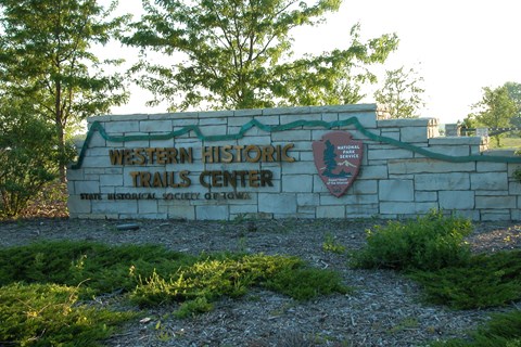 A stone-walled sign at the entrance of the western historic trails center.