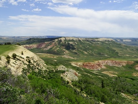 Profile of a ridge on the left looking across a valley to another ridge in the middle distance.