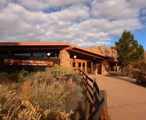 A building in front of a large cliff.