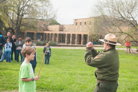 Park Ranger demonstrates using the atl atl at the Visitor Center