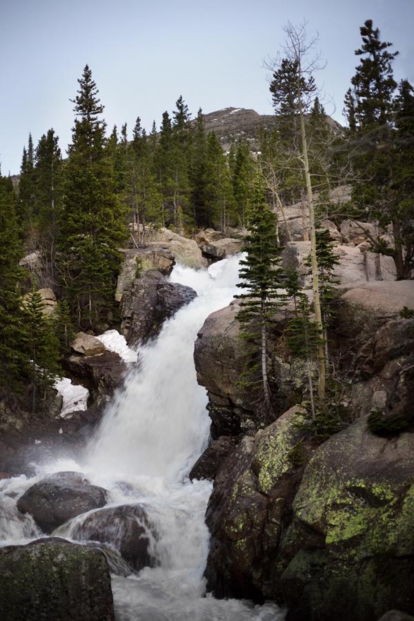 a waterfall flows over a rocky cliff