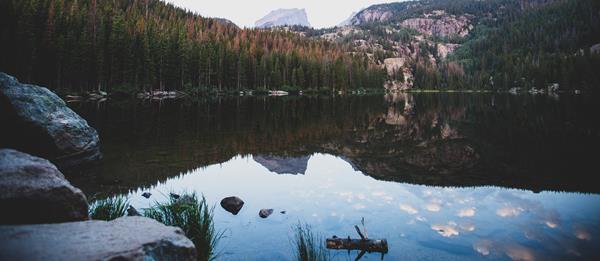 mountain peak reflected in clear calm lake