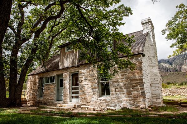 A house built with irregular stone walls painted white