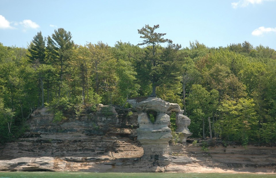 A lone pine tree survives atop Chapel Rock, an easily recognized formation of the Pictured Rocks.