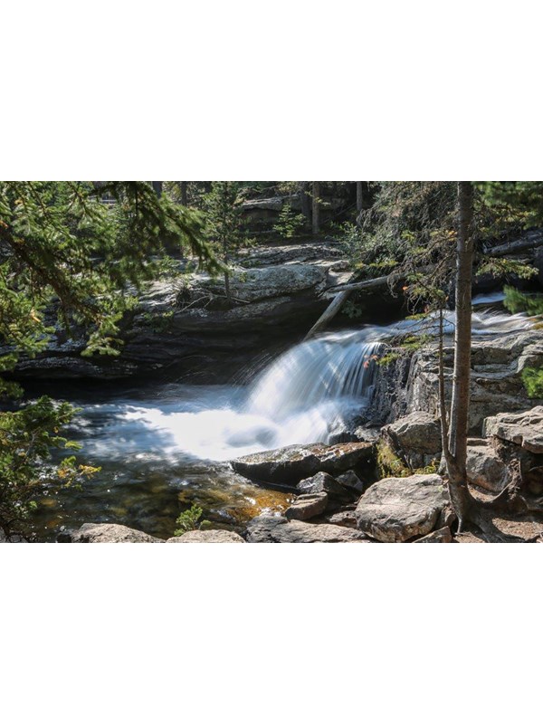 a waterfall flows over a rocky cliff