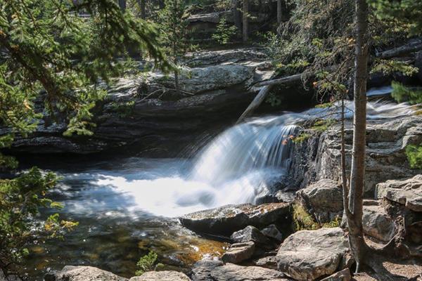 a waterfall flows over a rocky cliff