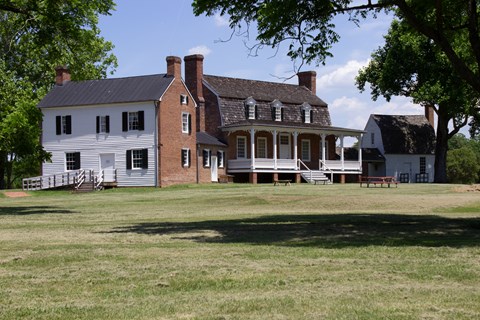 A two story brick building with two attached side buildings.
