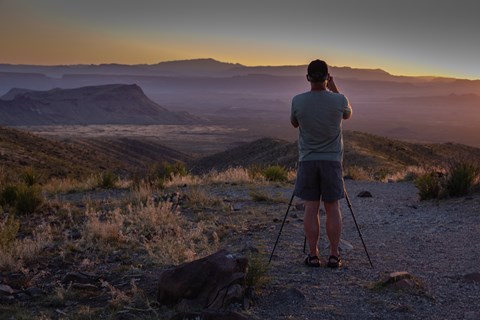 A photographer captures images of the sunset from Sotol Vista.