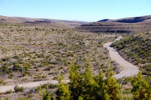 Photo showing Walnut Canyon Desert Drive meandering through the Chihuahuan Desert.