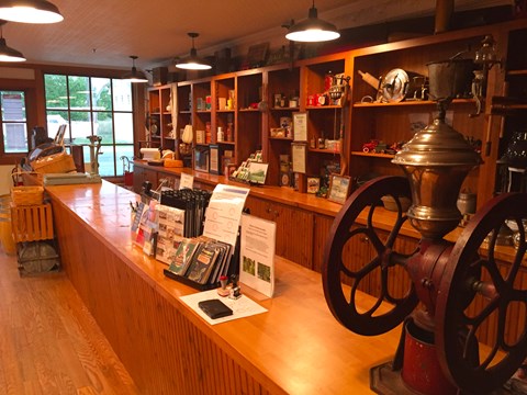 Shelves filled with historic items and an old coffee grinder on counter.