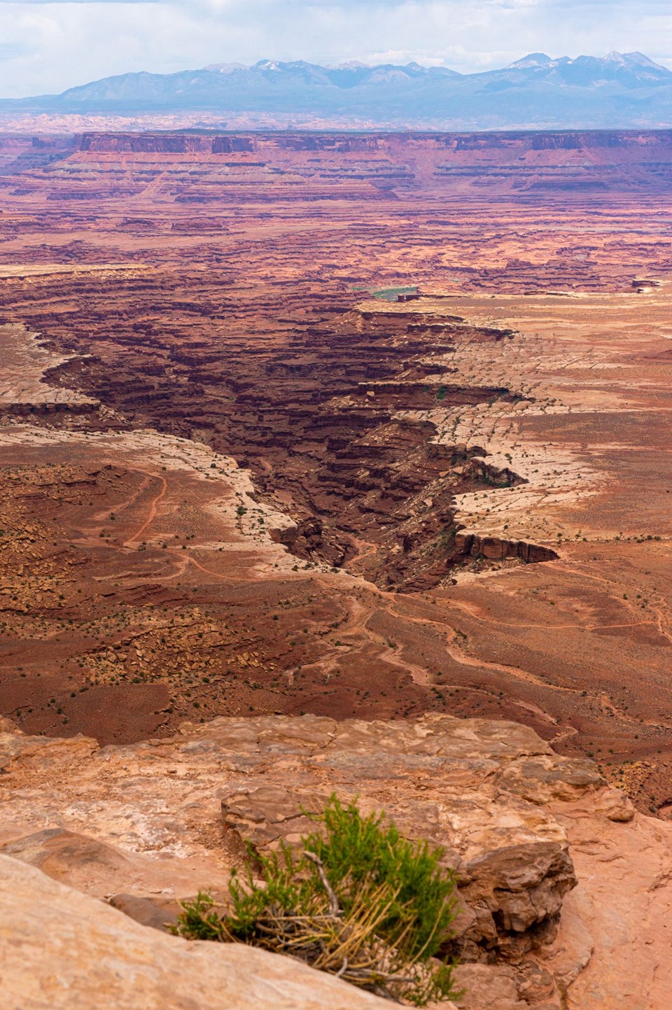 A sweeping view of multi colored canyons on a cloudy day