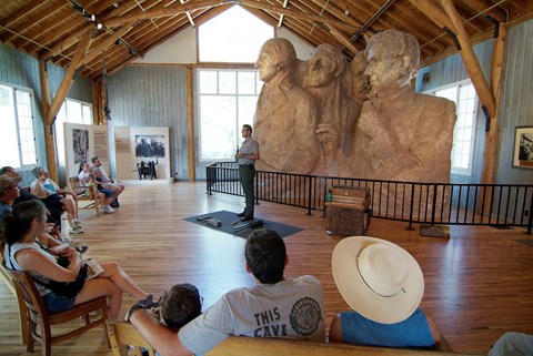 Photo of the interior of the Sculptor's Studio during a ranger talk, the scale model is in the back.