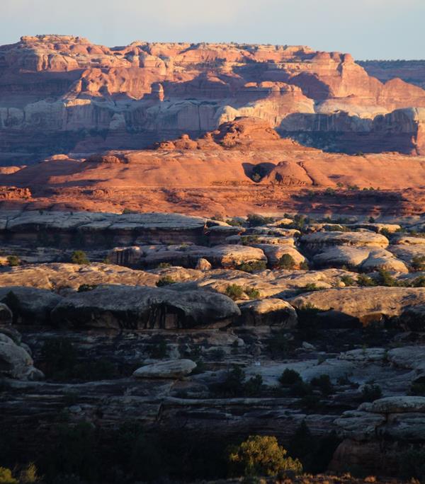 Multicolored geologic layers are highlighted at sunset