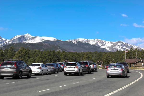 Line of vehicles waiting to enter Rocky at the Beaver Meadows Entrance Station
