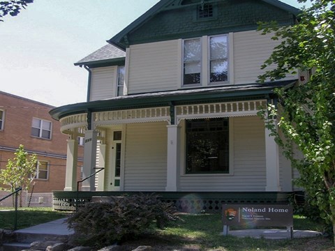 Green and yellow Victorian home with steps