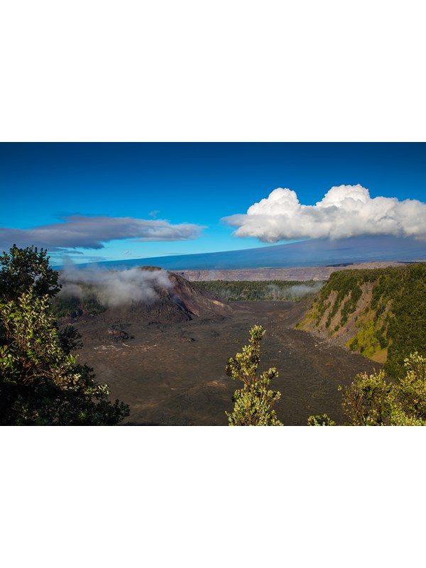 Volcanic crater with a large cinder cone on the left-hand side and a larger mountain beyond.