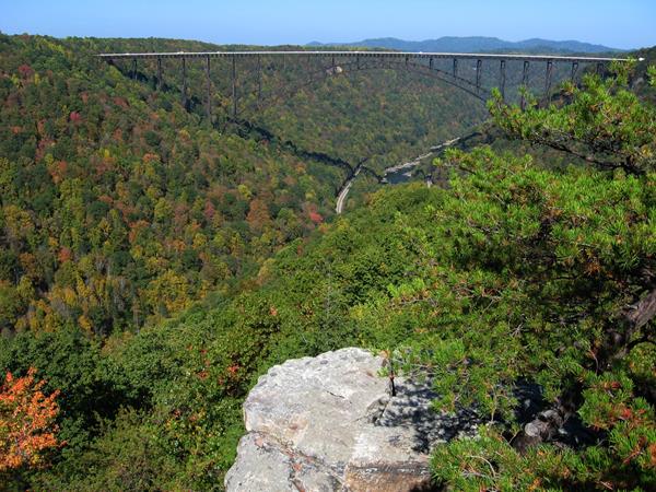 A view of the New River Gorge Bridge spanning river and deep gorge