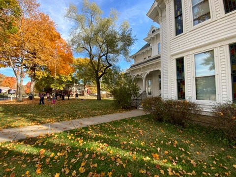 West side of Truman Home, autumn colors on trees and leaves on the ground
