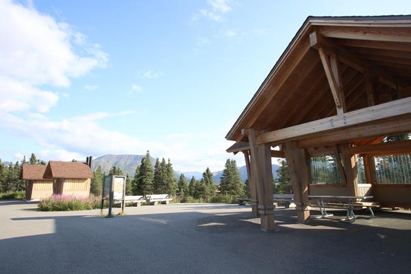 a large picnic shelter near rest rooms in a forest