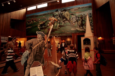 Children in the visitor center lobby exploring Revolutionary War-related exhibits
