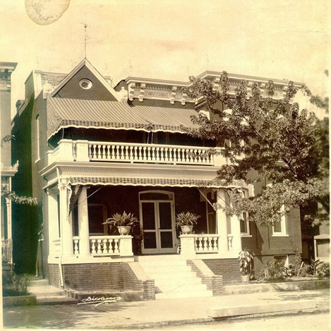 two-story house with front porch and balcony