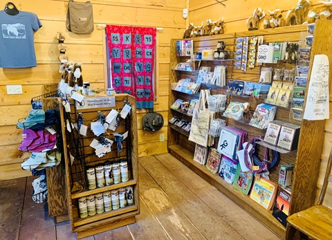 Inside view of the Grant-Kohrs Ranch park store. There are several items for sale on shelves.