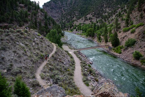 A footpath goes back and forth next to a narrow canyon and river