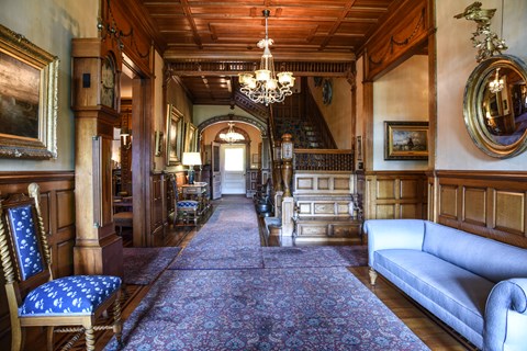 Entrance hallway of Victorian mansion with wood paneled walls