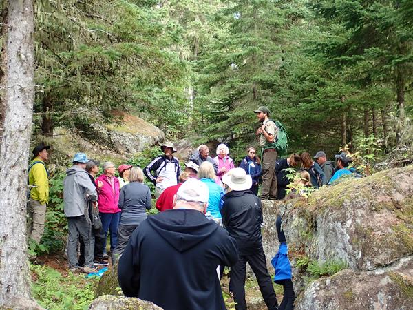 Park Ranger answers visitor questions on Isle Royale trail.