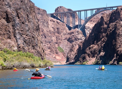Kayakers on a river in a canyon