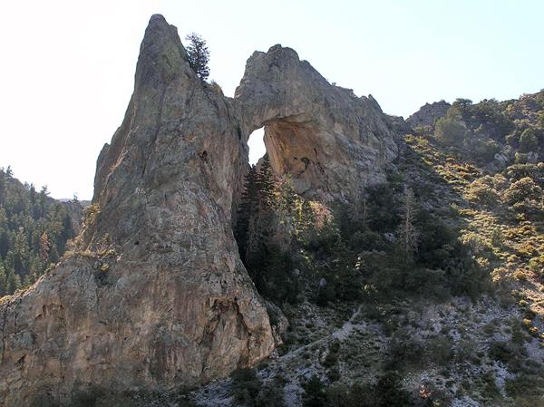 Large 200 foot limestone arch on the side of a canyon