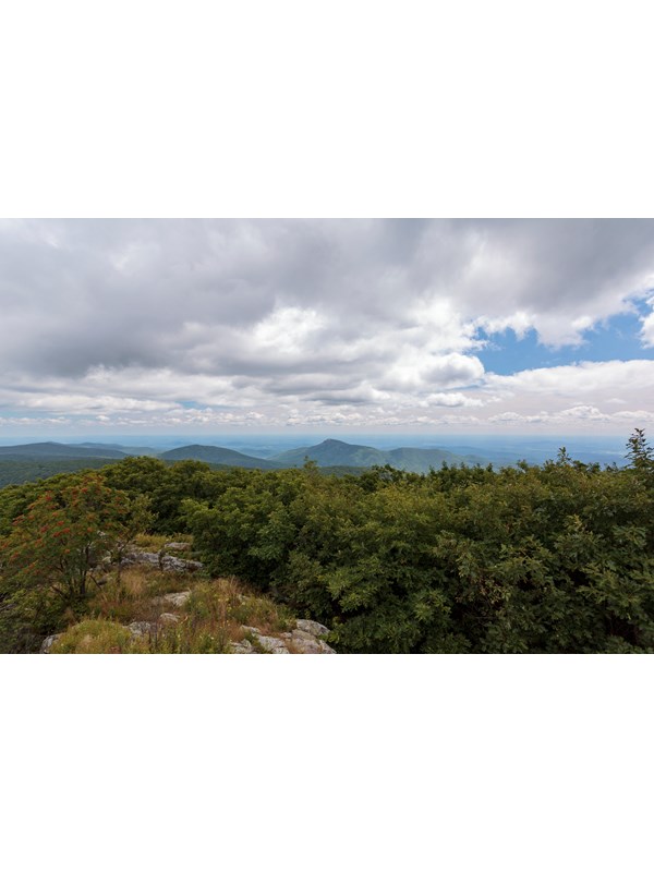 A view from on top of the summit of a mountain.