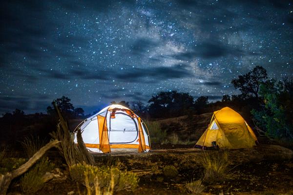 Two white and yellow tents illuminated the stars