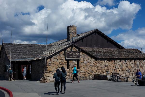 a rocky faced building with shingled roof