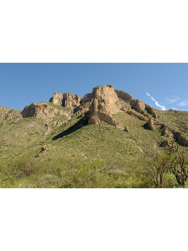 Photo of towering mountains above the Slaughter Canyon Trail.