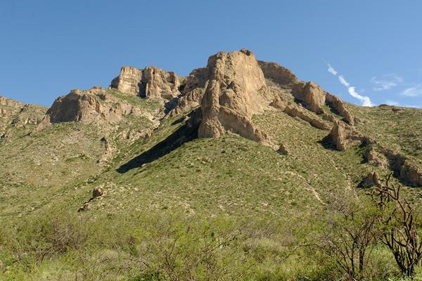 Photo of towering mountains above the Slaughter Canyon Trail.