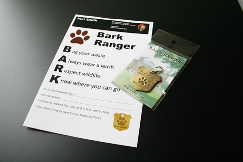 A handout titled BARK Ranger and the Fort Smith BARK Ranger dog tag.