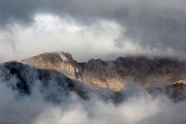 clouds frame a mountain peak