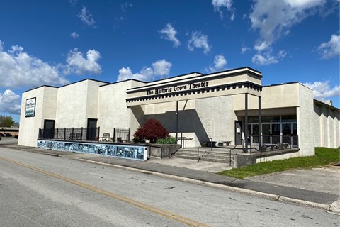 A large, white, blocky building with “The Historic Grove Theater” on the marquee.