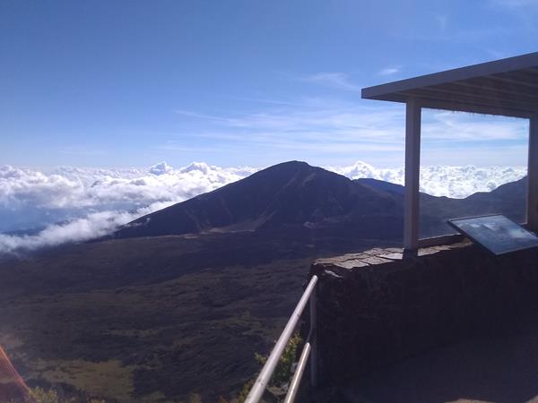A small shelter looks over a green volcanic valley.