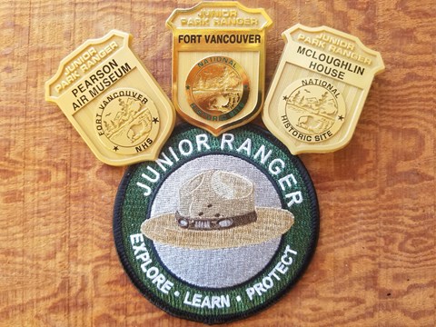 Three junior ranger badges and a patch.