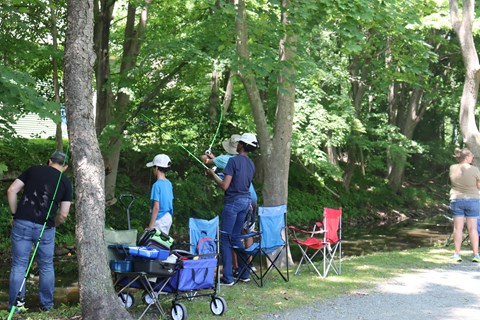 Group of people along Canal fishing poles