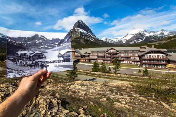 A hand holds historic photo aligned with actual historic hotel building